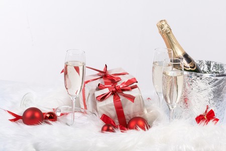 Christmas gift with tapes and a bottle of champagneの写真素材