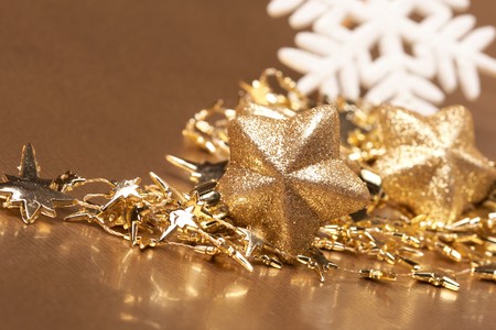Christmas gold stars on the gold backgroundの写真素材