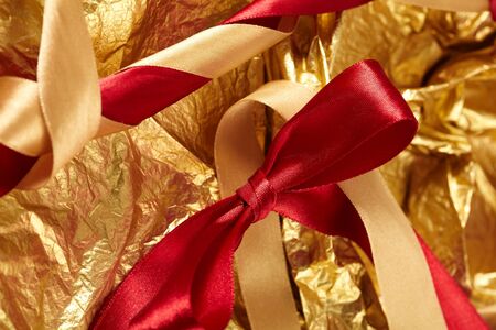 satin ribbons on the gold backgroundの写真素材