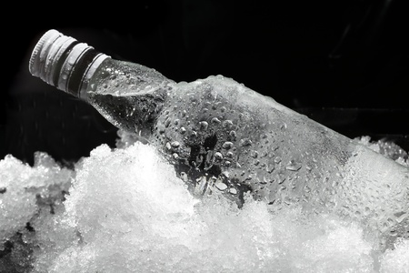 Close up view of the bottle in iceの写真素材