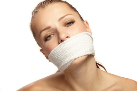 Cute young woman with white band on the mouthの写真素材