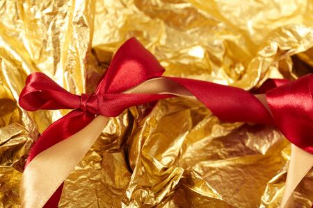 satin ribbons on the gold backgroundの写真素材