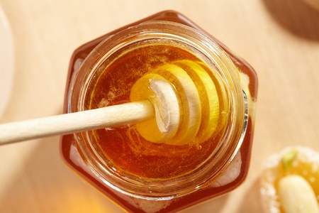 Honey with wood stick の写真素材