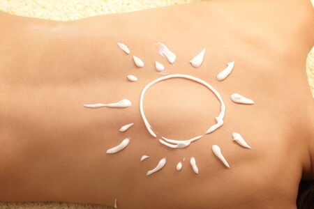 woman with sun-shaped sun cream 