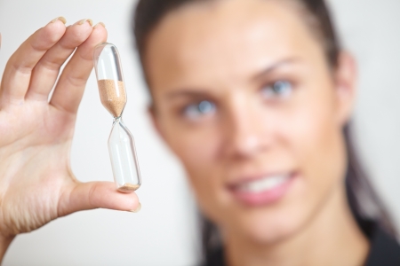 woman hand holding hourglass