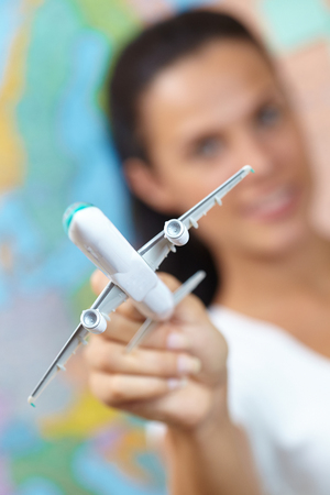 Young Woman Holding Airplaneの写真素材