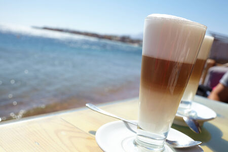 Latte on a cafe tableの写真素材