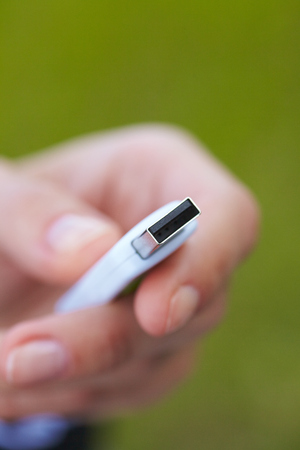 hand holding black USB data storageの写真素材