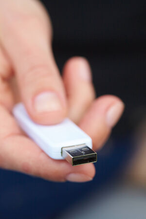 hand holding black USB data storage
