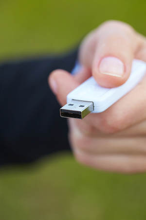 hand holding black USB data storageの写真素材