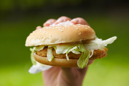 woman eating hamburgerの写真素材