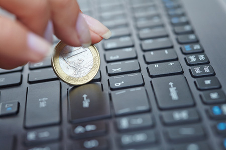 coin on laptopの写真素材