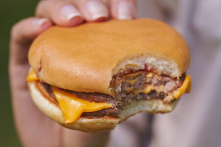 woman eating hamburgerの写真素材