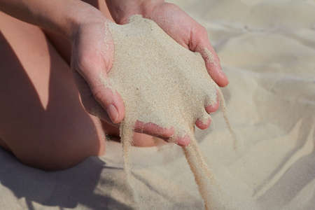 hand pours sandの写真素材
