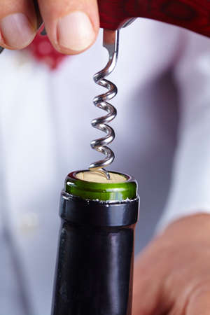 man opening a bottle of wineの写真素材