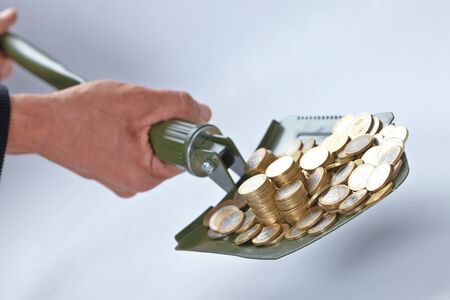 shovel with moneyの写真素材