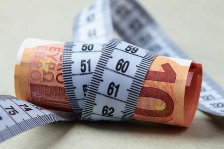 euro with measuring tapeの写真素材