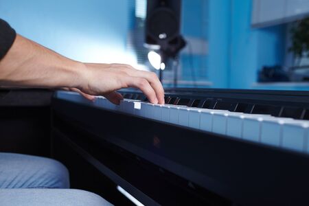 Playing the piano keyboard close upの写真素材