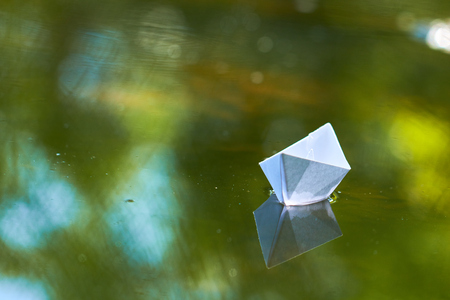paper boat on the waterの写真素材