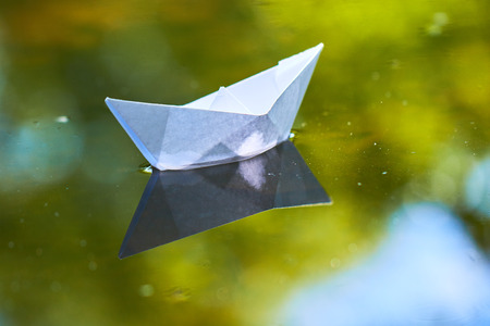 paper boat on the waterの写真素材