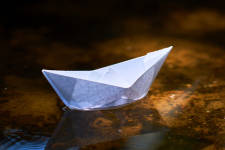 paper boat on the waterの写真素材