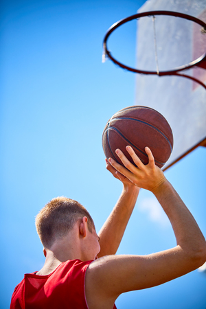 man holding a basketballの写真素材