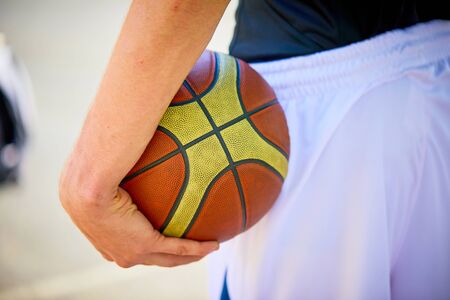 man holding a basketballの写真素材
