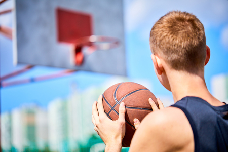 male playing basketball outdoorの写真素材