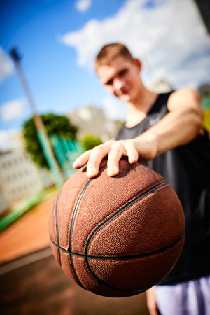male playing basketball outdoor