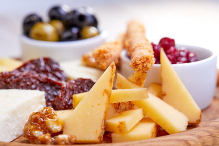 cheese plate with olivesの写真素材