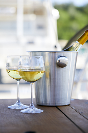 Pair of wineglasses against the yachtの写真素材