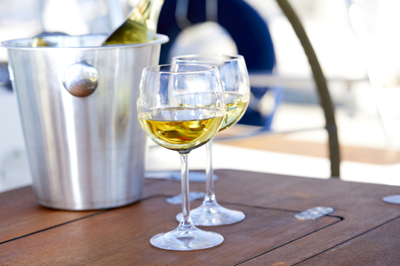 Pair of wineglasses against the yachtの写真素材