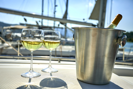 Pair of wineglasses against the yachtの写真素材