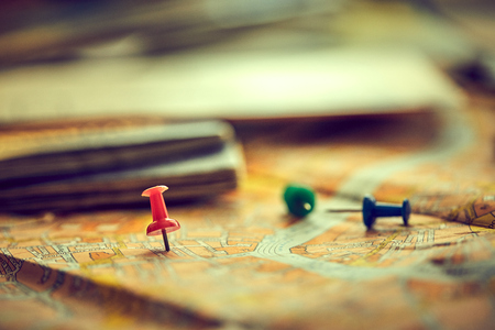 Pins marking travel itinerary points on map and passportの写真素材