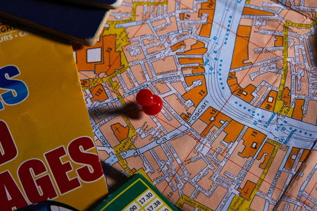 Pins marking travel itinerary points on map and passportの写真素材