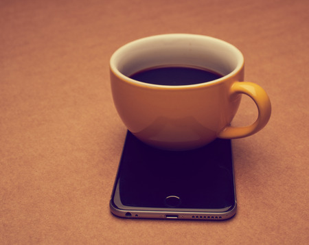 smartphone and cup of coffeeの写真素材