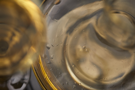 A glass full of wine and wine decantersの写真素材