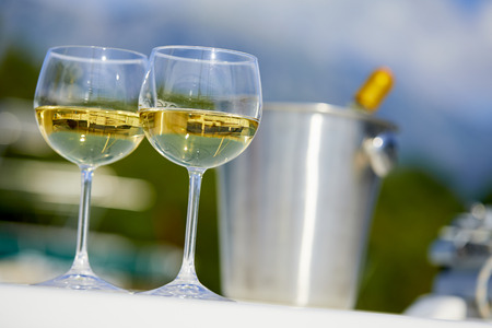 Pair of wineglasses against the yachtの写真素材