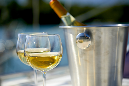 Pair of wineglasses against the yachtの写真素材