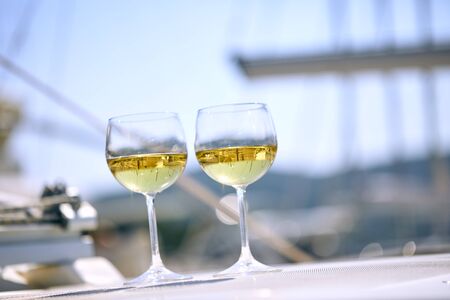 Pair of wineglasses against the yachtの写真素材