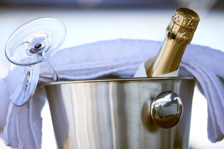 Romantic luxury evening on cruise yacht with champagne setting. Empty glasses and bottle with champagne and tropical sunset with sea backgroundの写真素材