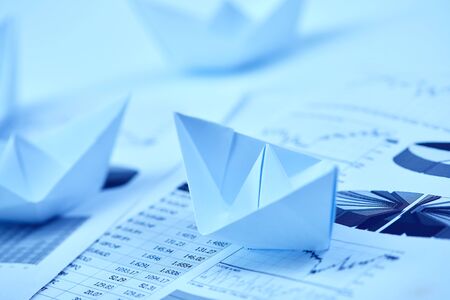 Paper boat on business graphの写真素材
