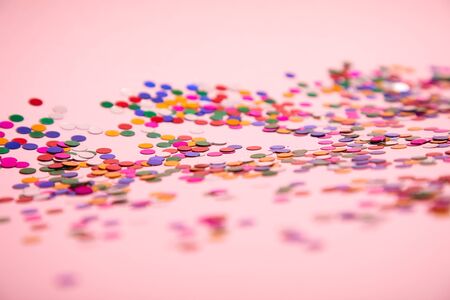 Colorful confetti on pinkの写真素材