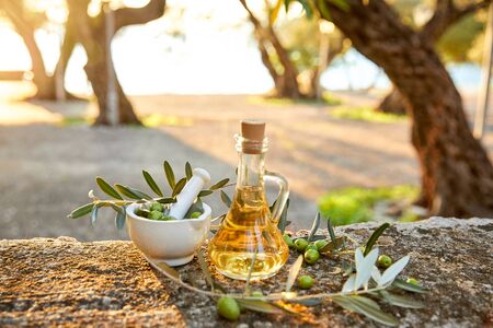 olive oil with fresh olives and leavesの写真素材