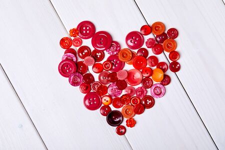Multicolored antique buttons on white