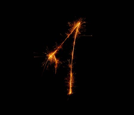 number one written with a sparkler on a black backgroundの写真素材