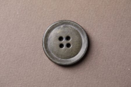  antique button on the brown backgroundの写真素材