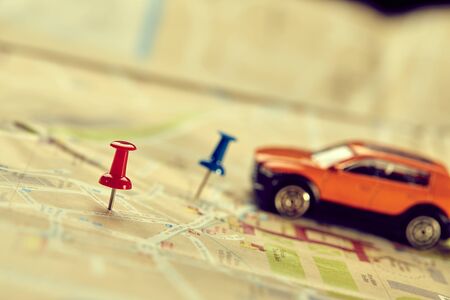 travel concept - small toy car on the map