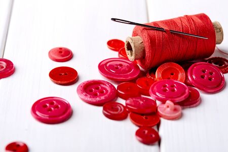 Multicolored antique buttons and sewing tools
