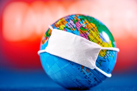 concept, globe in a protective mask on alarm background, epidemic, danger of peaceの写真素材